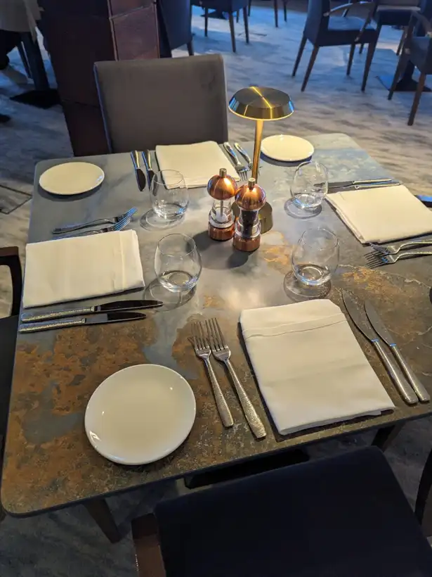 Infinity Surfaces porcelain dining table tops in a restaurant, supplied by Clay International